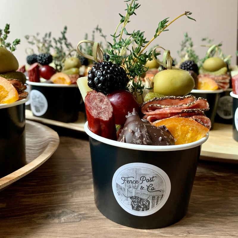 Charcuterie cups with meat, cheeses, fruit, nuts, olives, pickles and accompaniments in a single-serve cup. 9 oz. option.