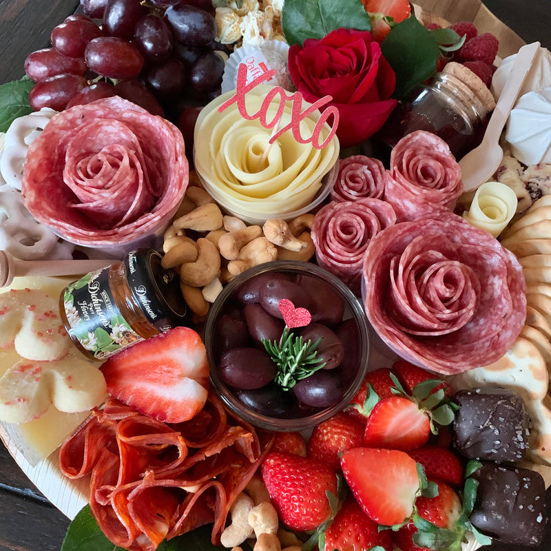 Charcuterie meats, cheeses, fruit, nuts, olives, pickles and accompaniments on a platter. Serves 6-8 as appetizer portions. The Galentine for Valentine's Day.