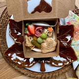 Charcuterie meat, cheeses, fruit, nuts, olives, pickles and accompaniments on a tray inside a Kraft box. Serves 1 as appetizer portion. The Guest Box.